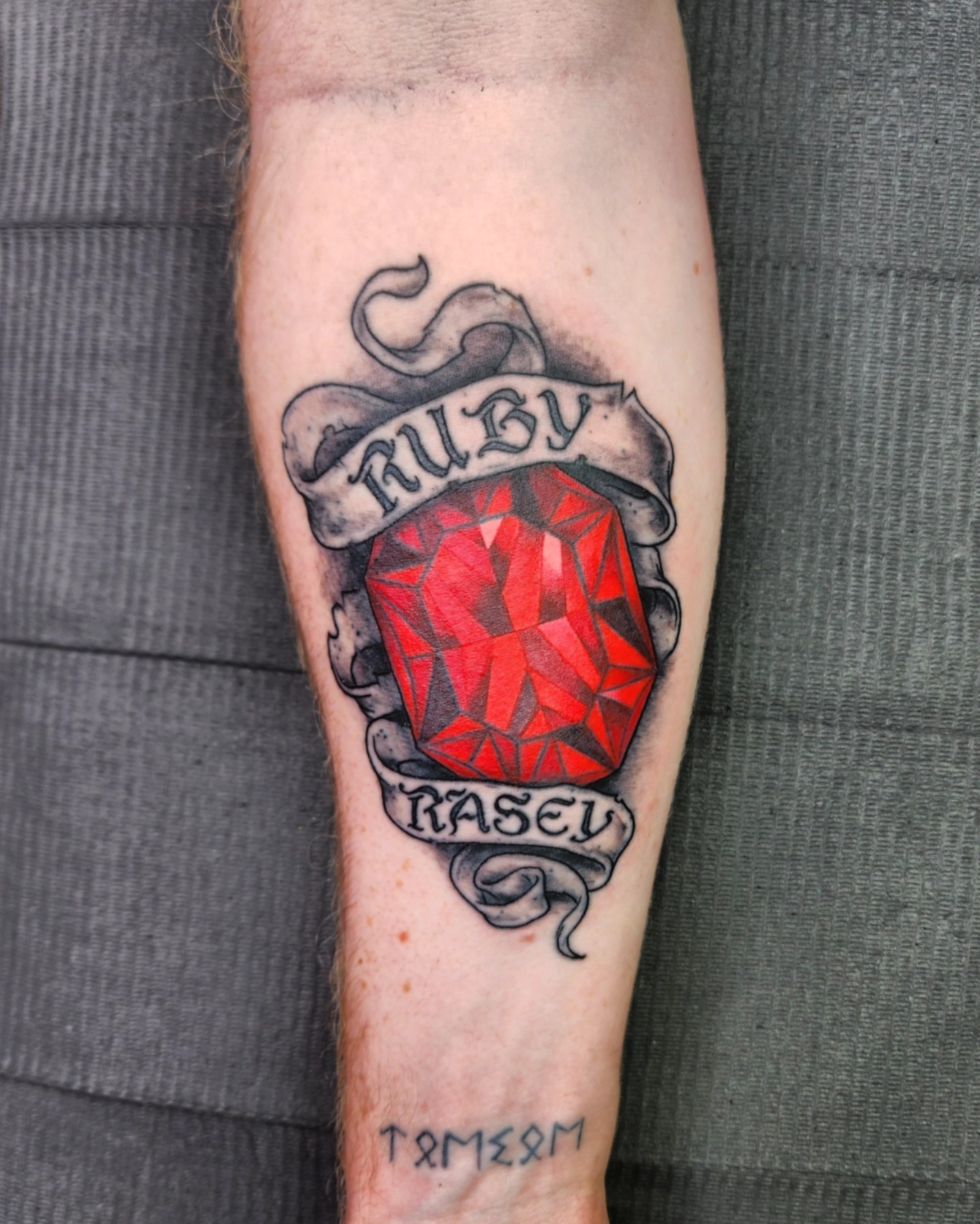 Ruby American traditional tattoo on the forearm by Bry True