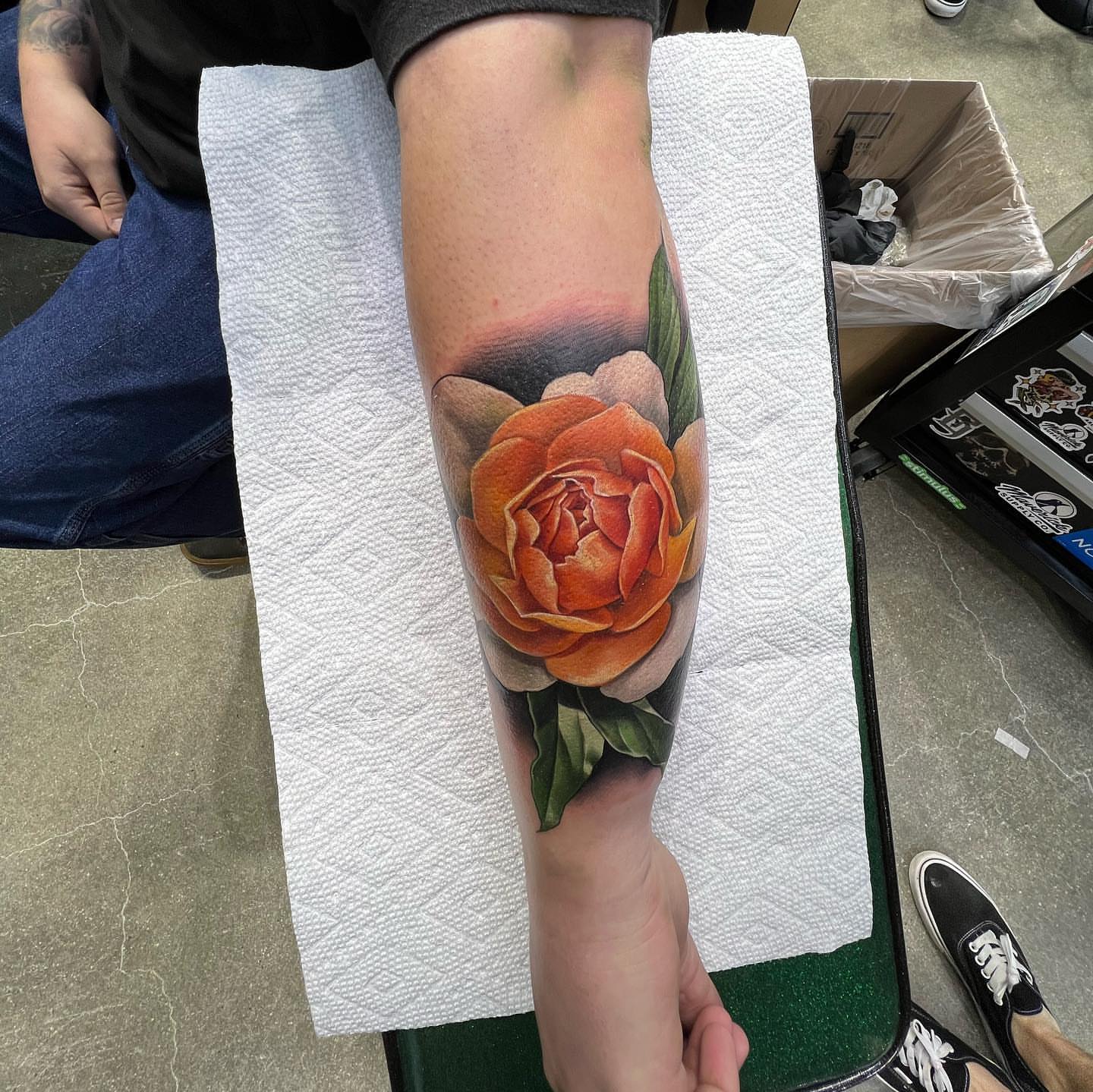 Orange rose realism tattoo on the forearm by Derek Gardner