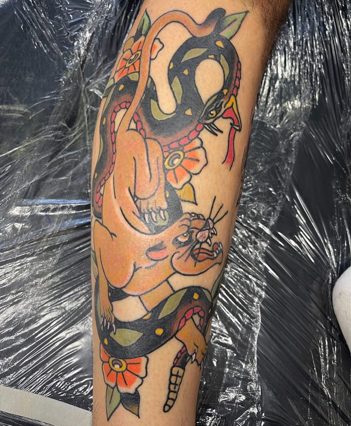 Snake and peony American traditional tattoo on the forearm by Blake Brand
