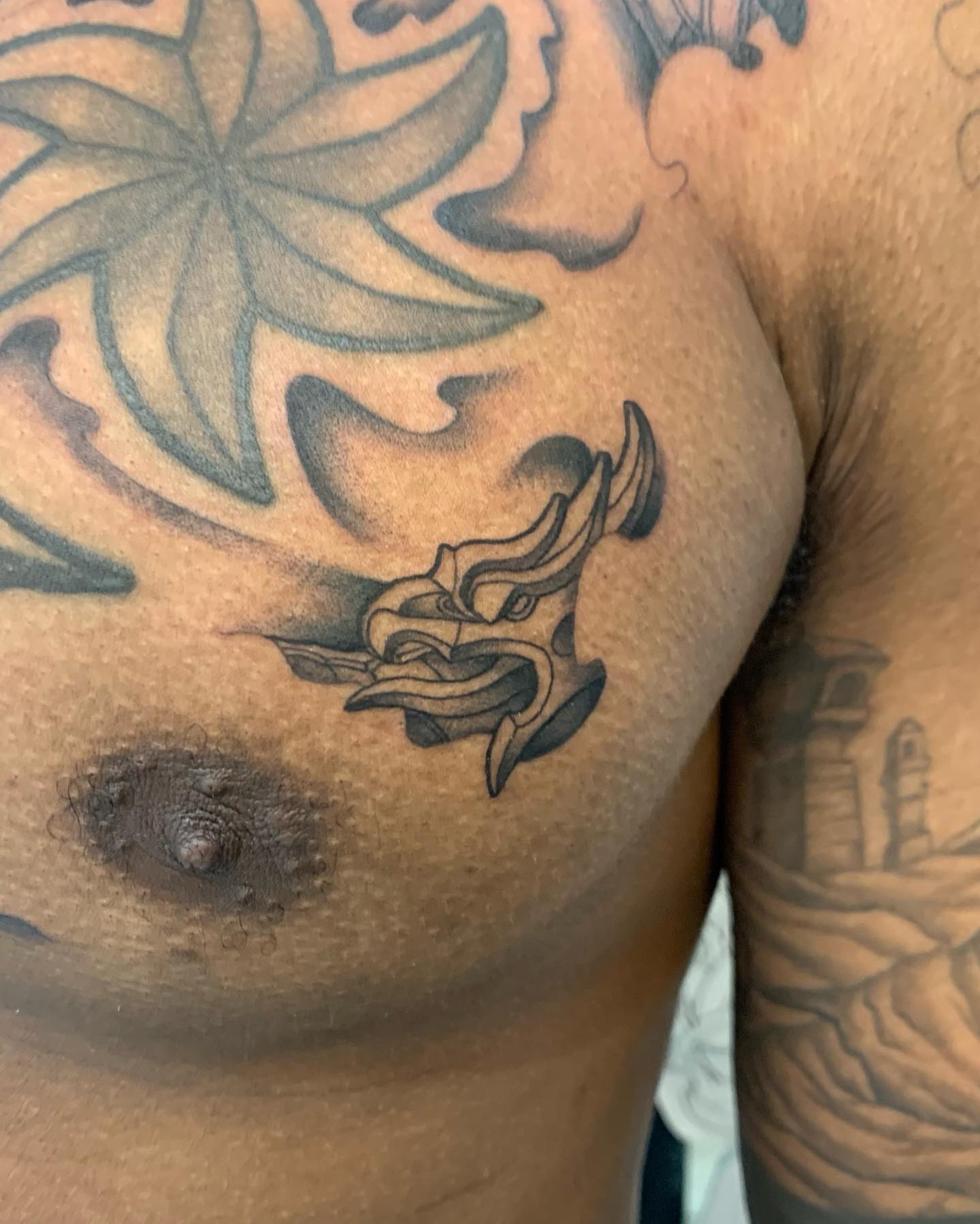 Lotus flower black and grey tattoo on the chest by Mike G.