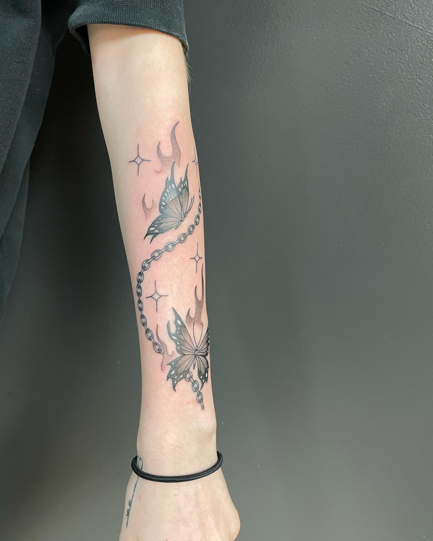 Butterfly and chain black and grey tattoo on the forearm by Las Vegas Tattoo Artist