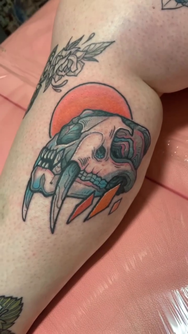Saber-toothed cat skull neo-traditional tattoo by Riley Oats