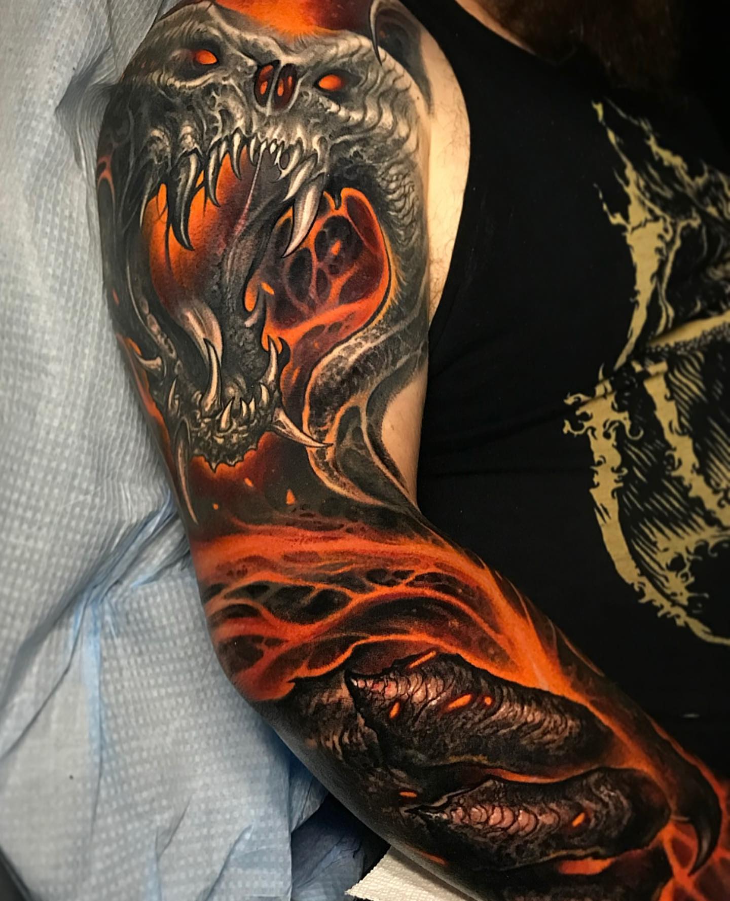 Demon skull dark realism tattoo on the upper arm by Brandon Herrera
