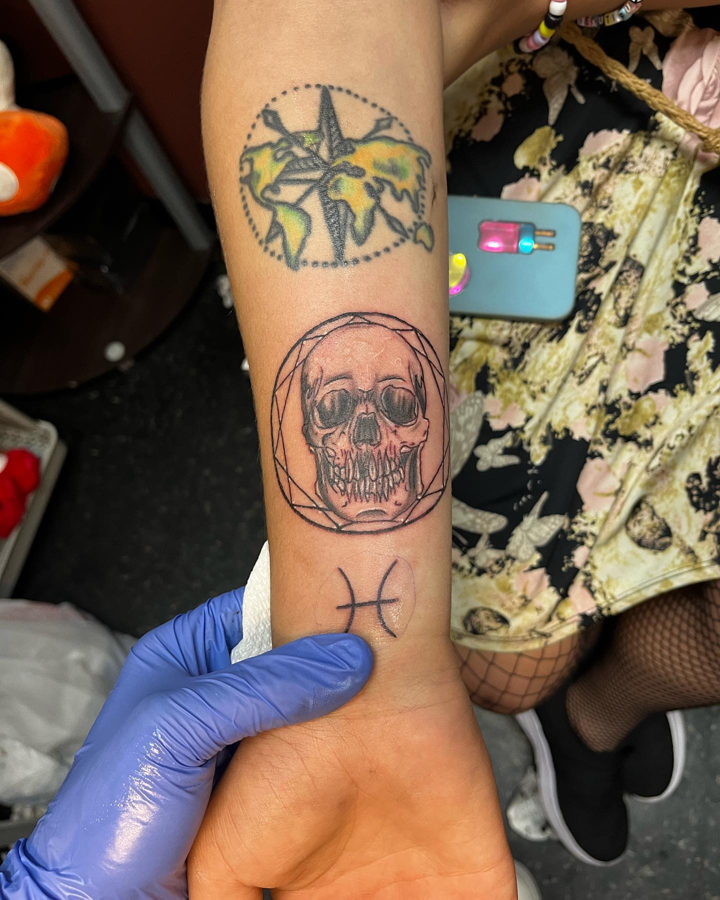 Skull and zodiac sign geometric tattoo on the forearm by Alyssa Turner