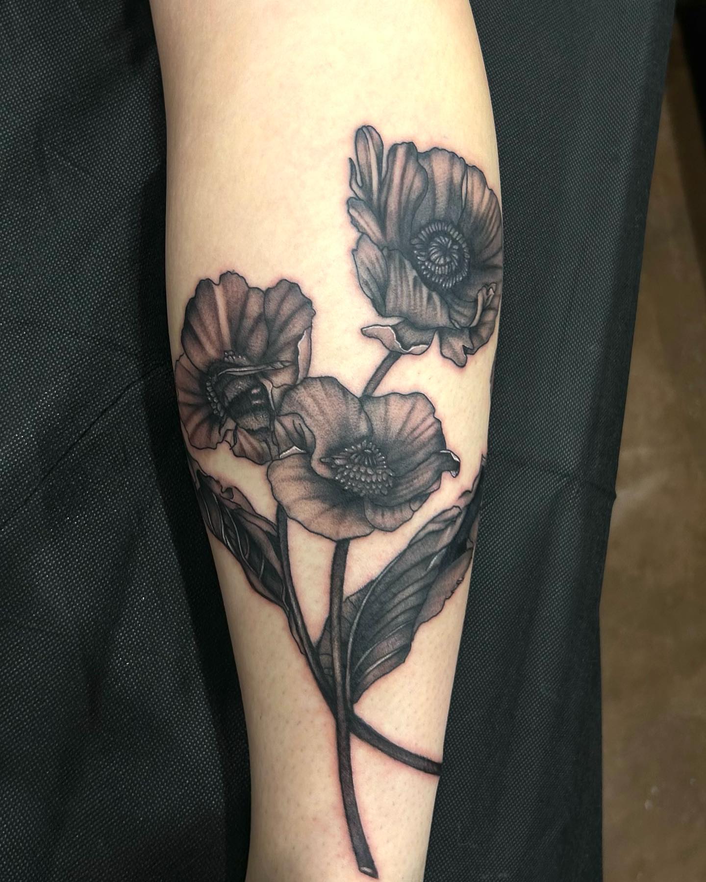 Poppy flowers realism tattoo on the forearm by Anahi