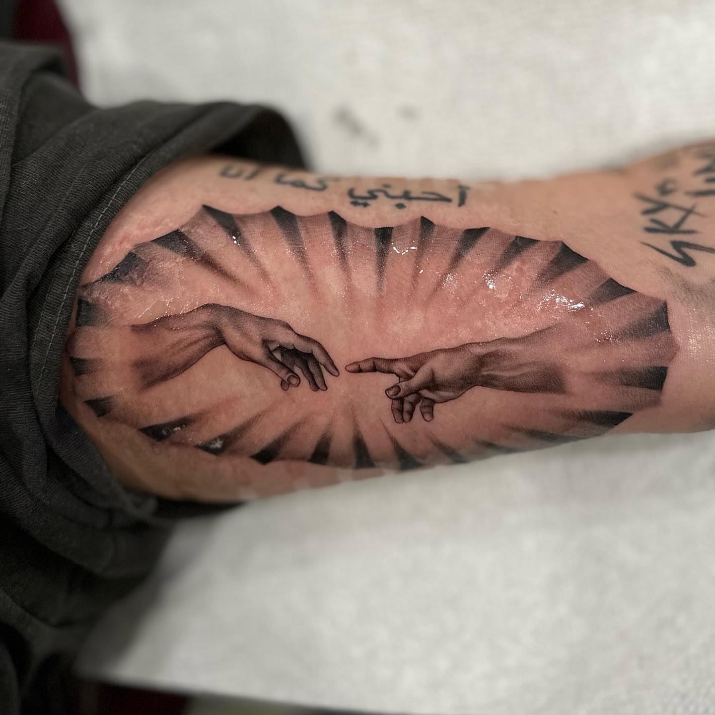 Creation scene realism tattoo on the forearm by Cesar Nava