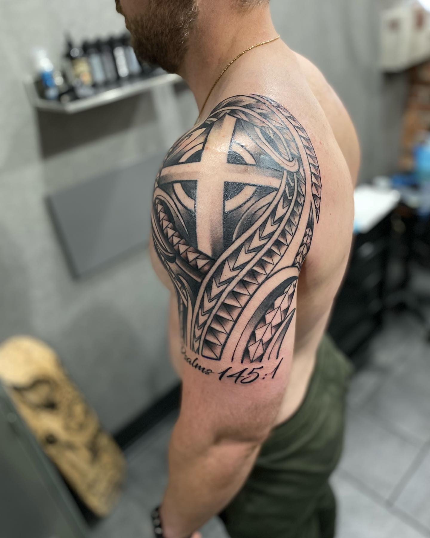 Cross and tribal patterns tribal tattoo on the shoulder by Brian Keith