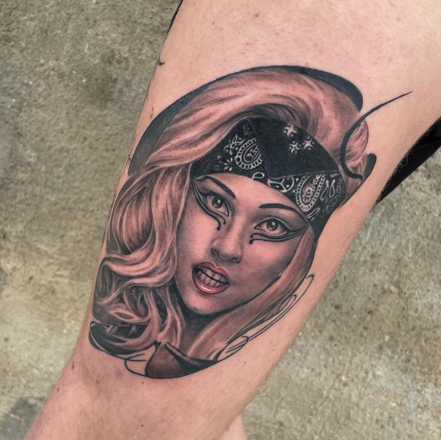 Woman wearing bandana realism tattoo on the forearm by mike hudson