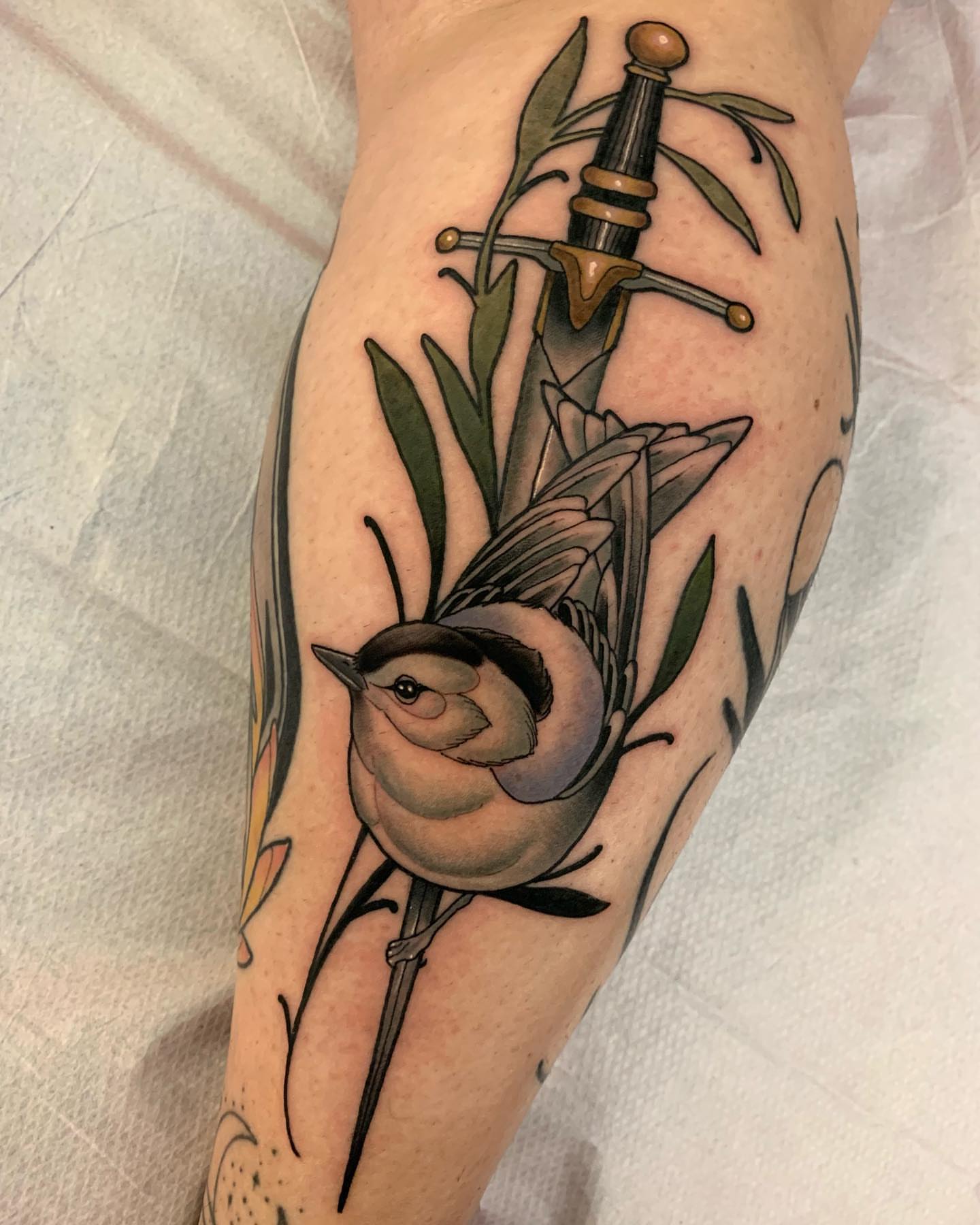 Bird and sword American traditional tattoo on the forearm by Luis Torres, Harrison, New Jersey