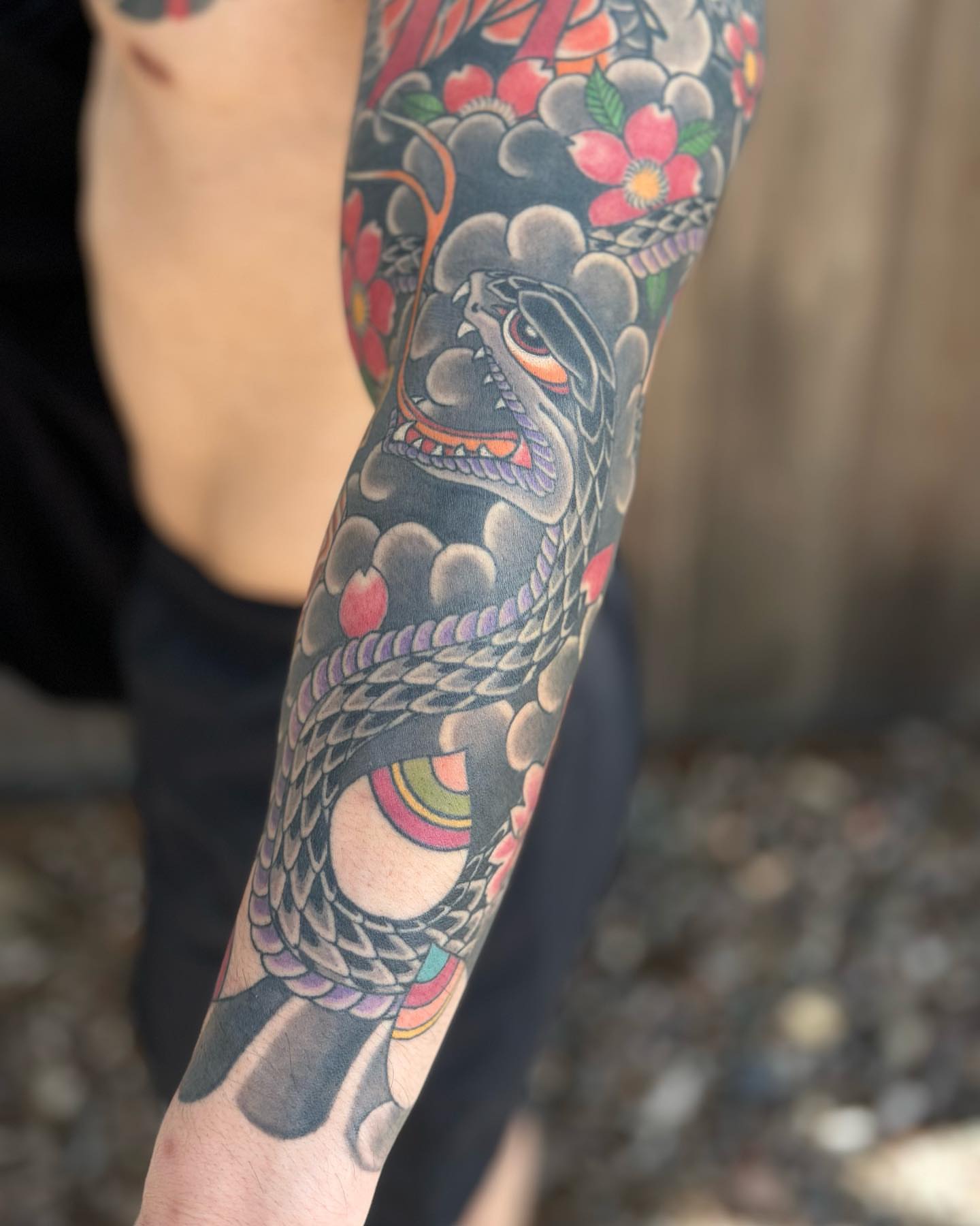 Snake and peony japanese irezumi tattoo on the forearm by Kenny Waizumi ๐