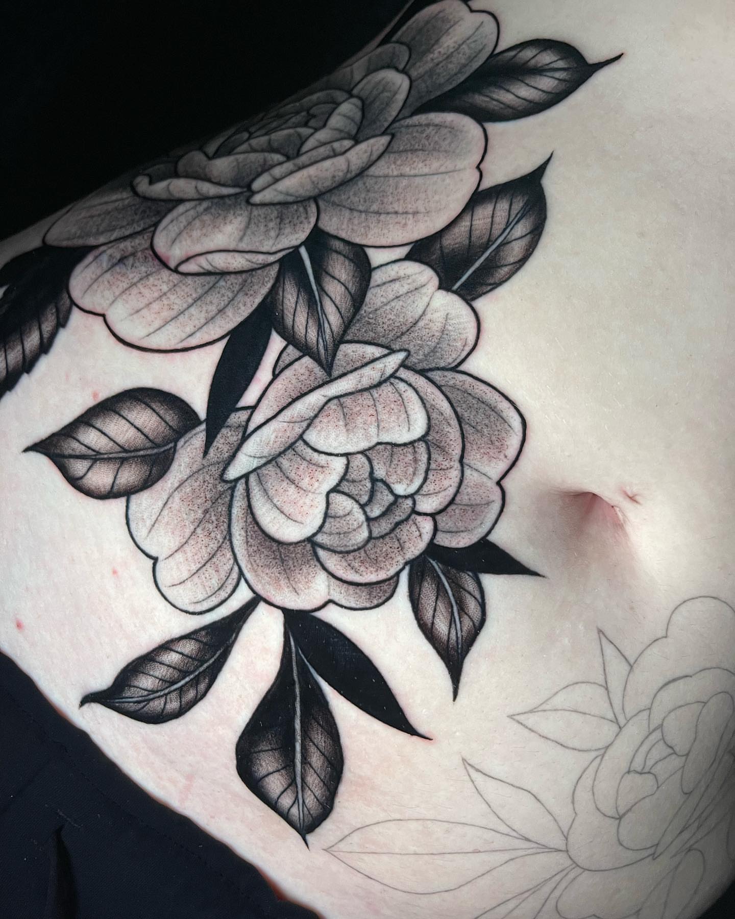 Roses black and grey tattoo on the torso by Amber