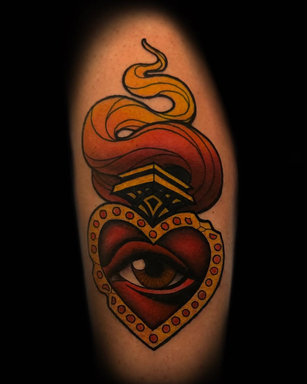 Sacred heart with eye and flame American traditional tattoo on the forearm by Dennis Alejandro