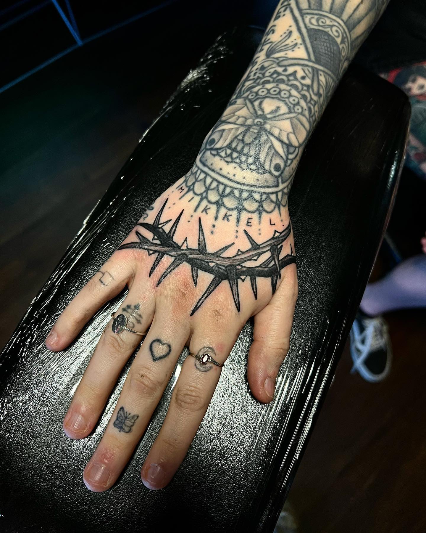 Barbed wire crown black and grey tattoo on the hand by Daniel Patrick