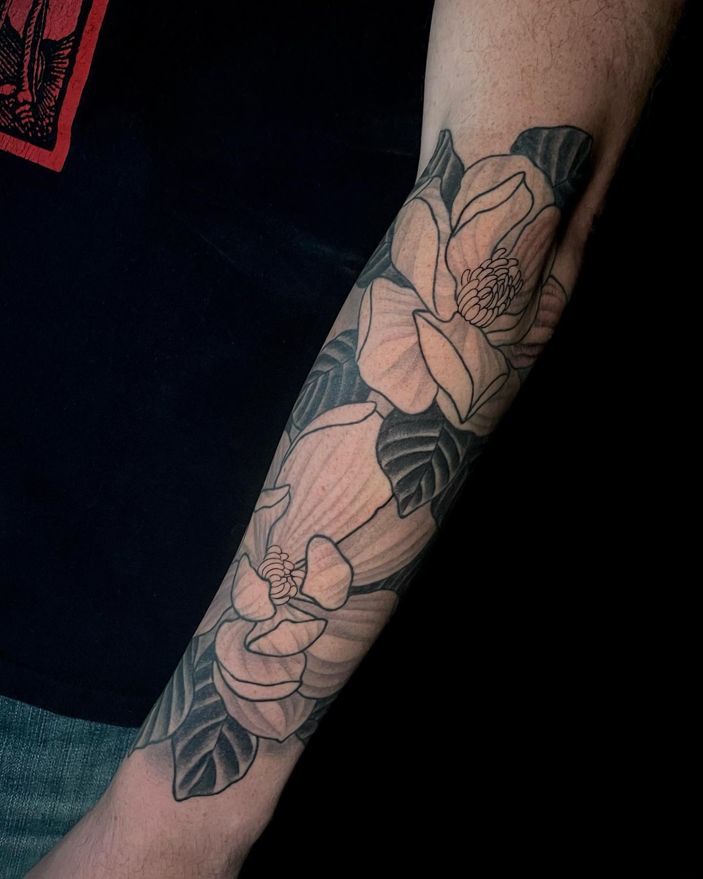 Magnolia flowers black and grey tattoo on the forearm by Amber