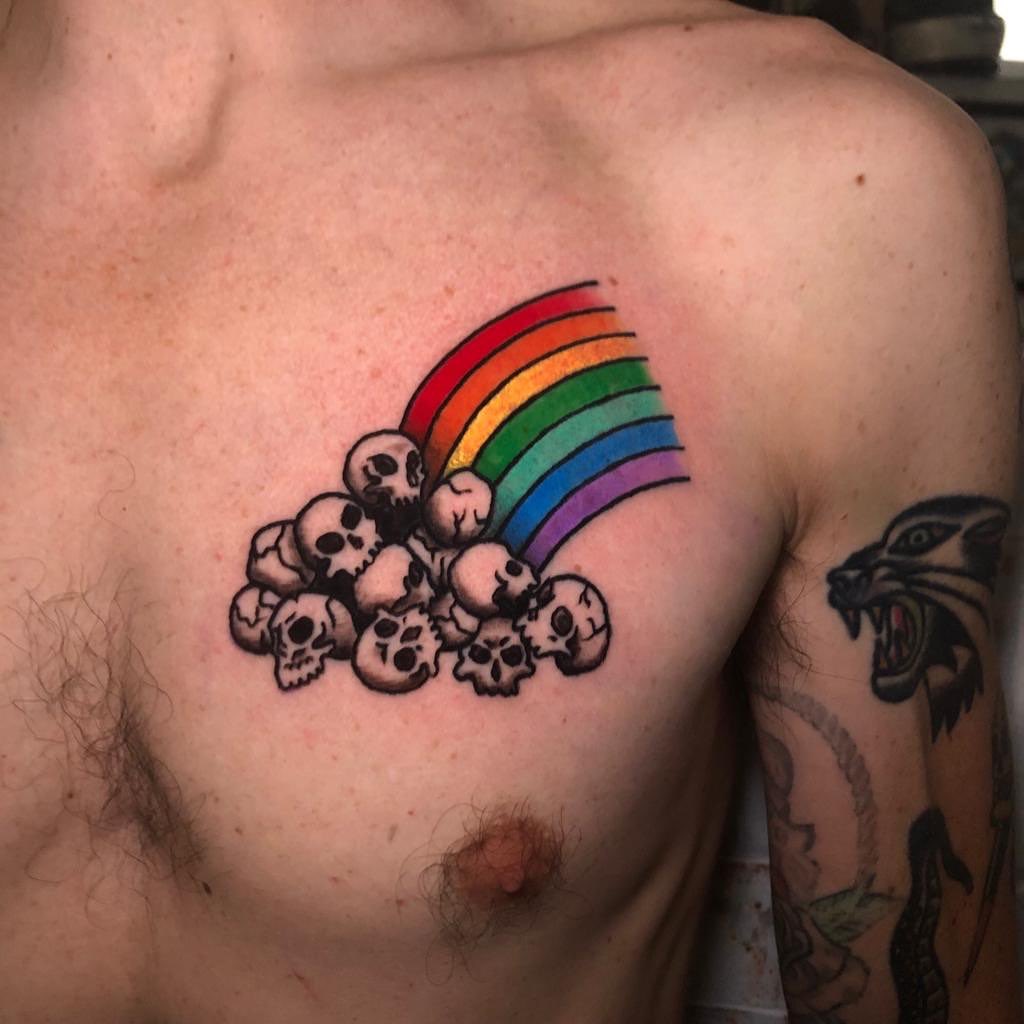 Rainbow and skulls trash polka tattoo on the chest by Marta La Jirafa