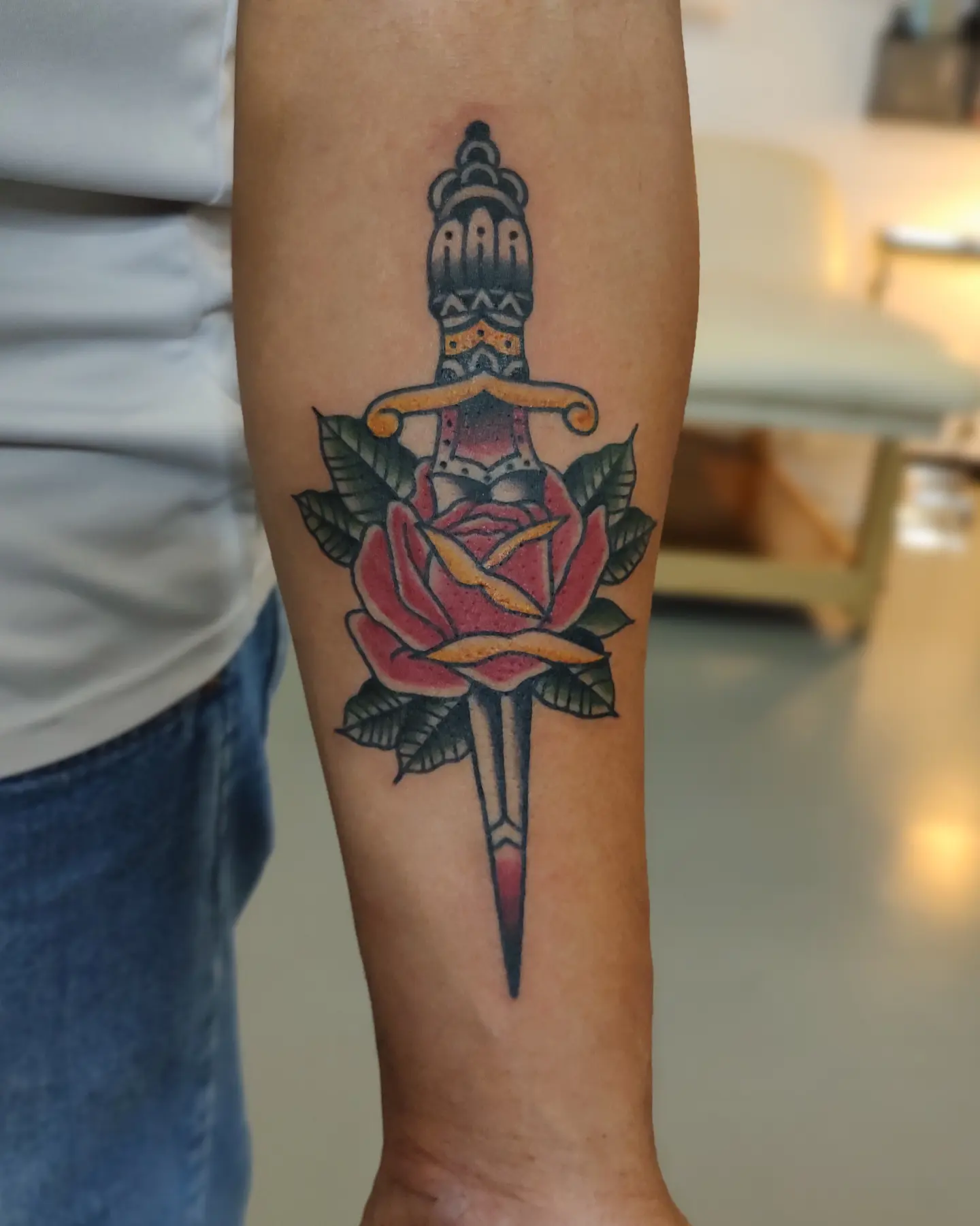 Sword and rose American traditional tattoo on the forearm by Herc