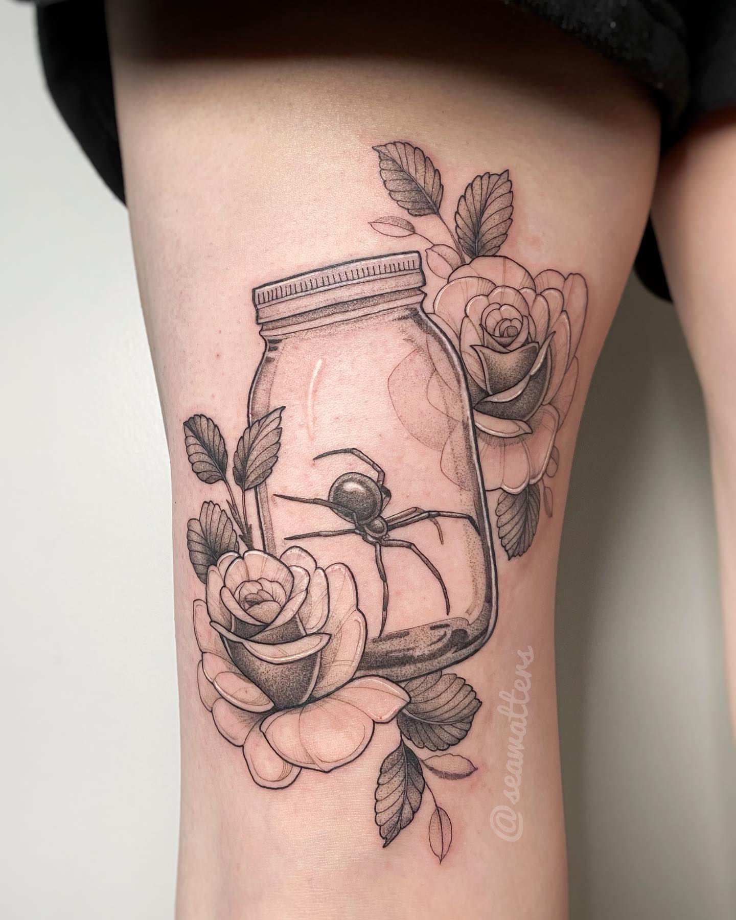 Jar with spider and roses realism tattoo on the forearm by Caitlin Watters