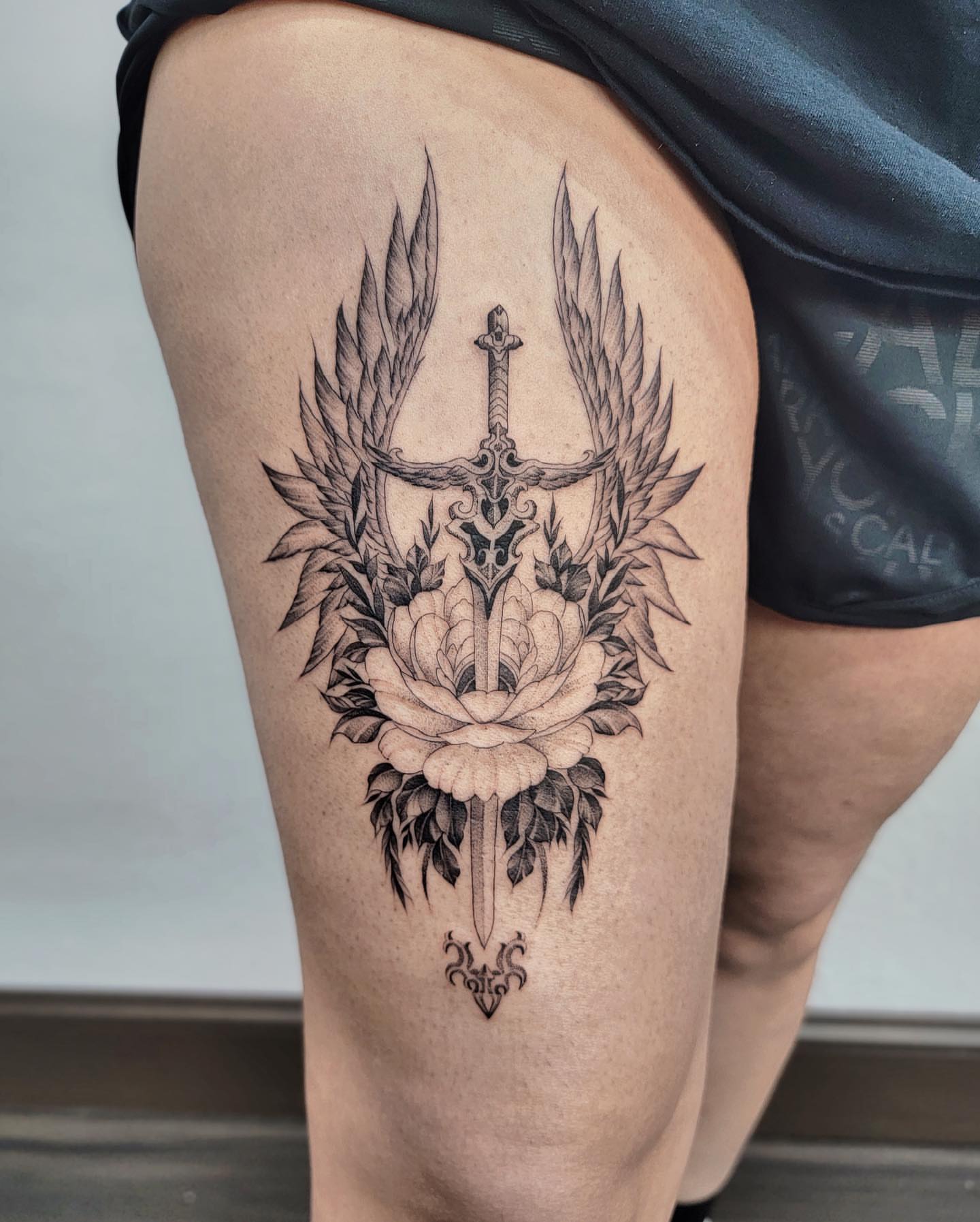 Sword and rose geometric tattoo on the thigh by Houston Tattoo Artist