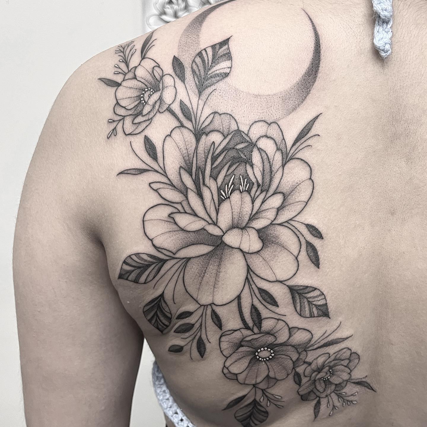 Floral bouquet dotwork tattoo on the shoulder by liliana lopez