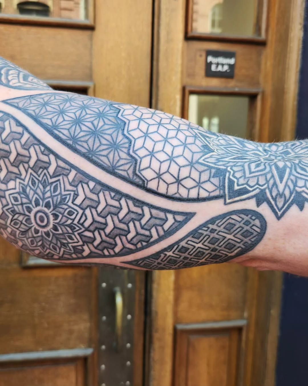 Geometric patterns dotwork tattoo on the forearm by Ravi Chandra, Mount Shasta, California