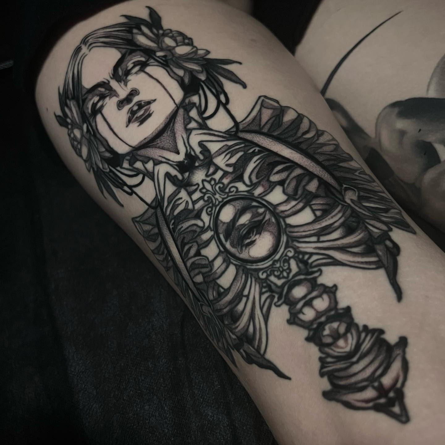 Woman with flowers realism tattoo on the thigh by Tony Trophy