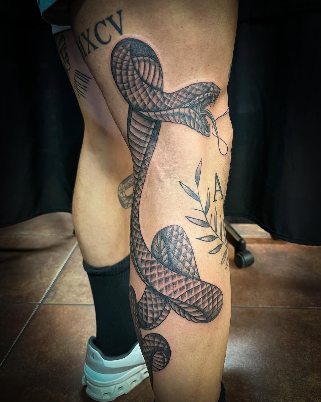 Snake with roman numerals and leaves American traditional tattoo on the leg by Melissa Peña NYC