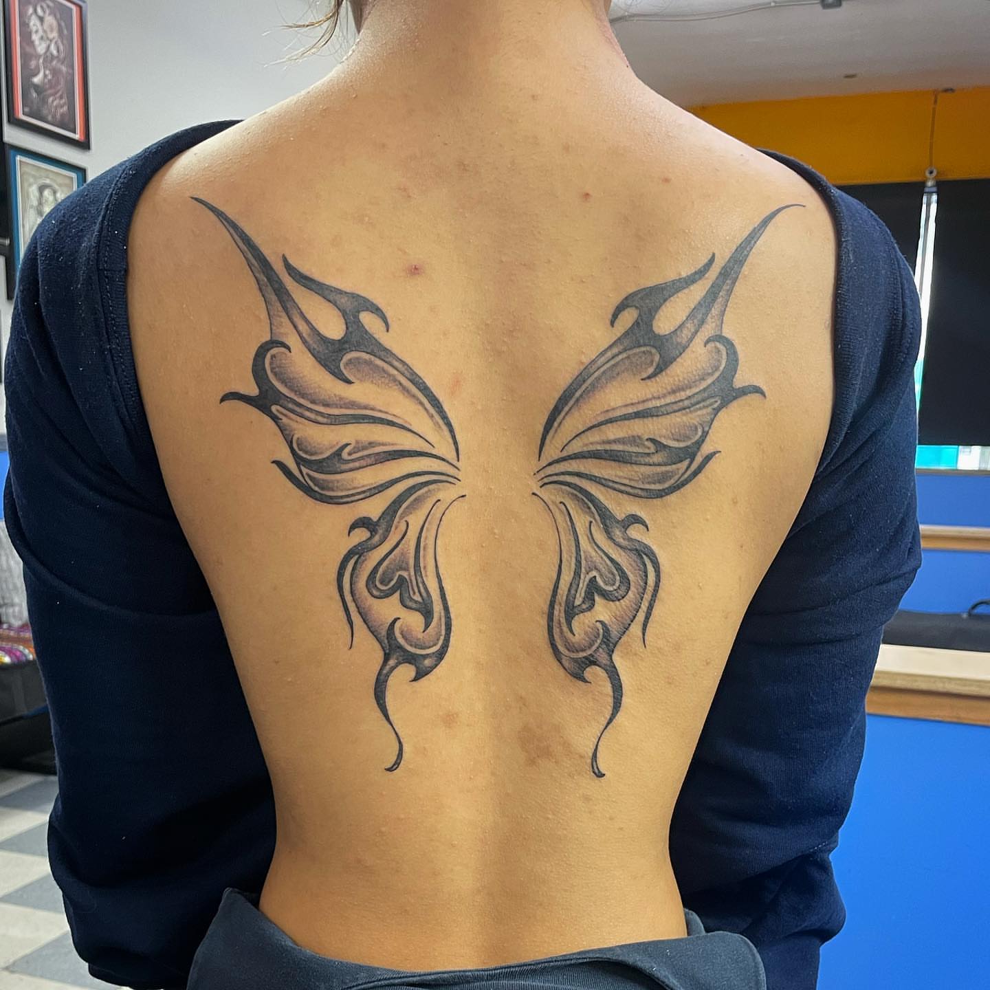 Butterfly tribal tattoo on the back by Manny