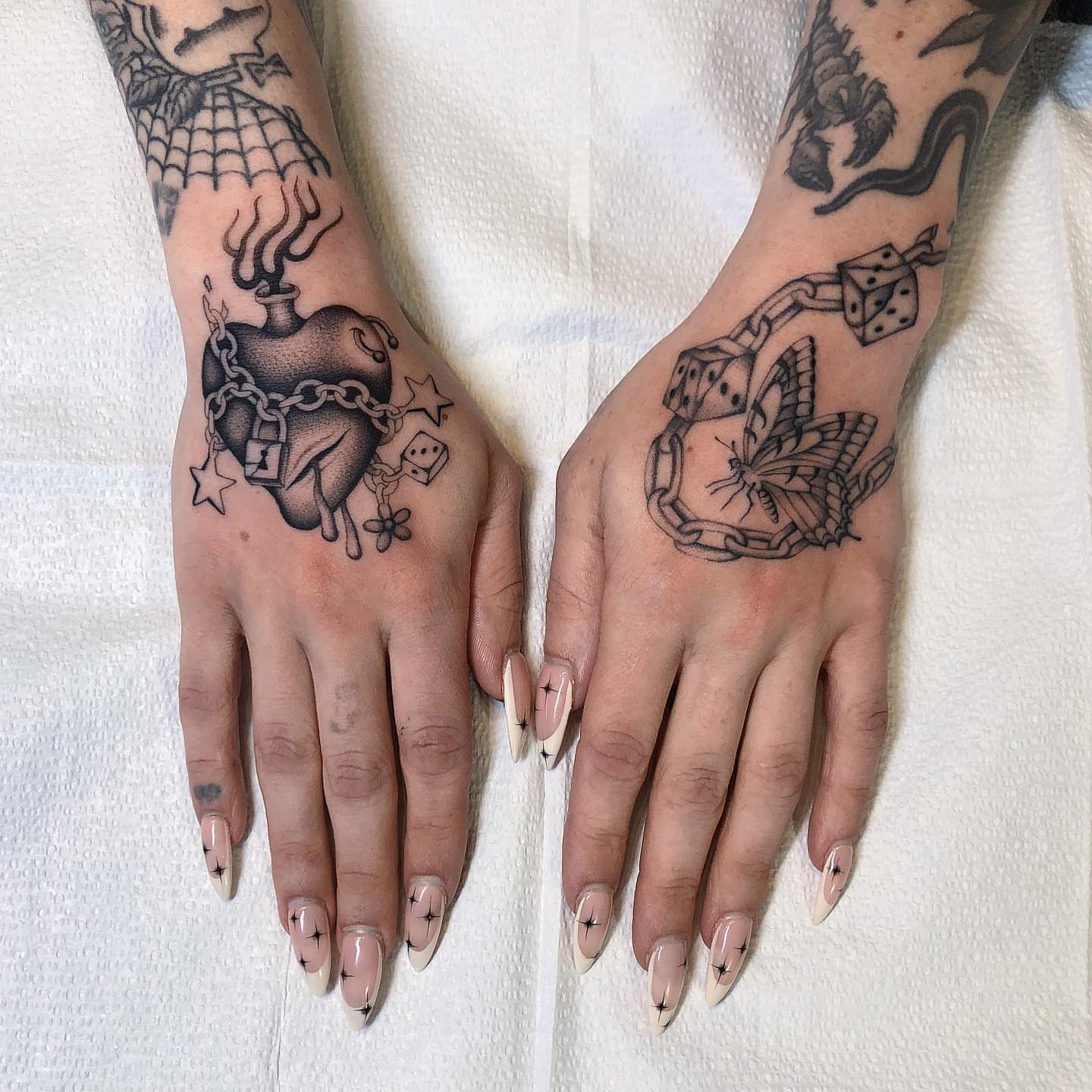 Heart and chain American traditional tattoo on the hand by Mickey