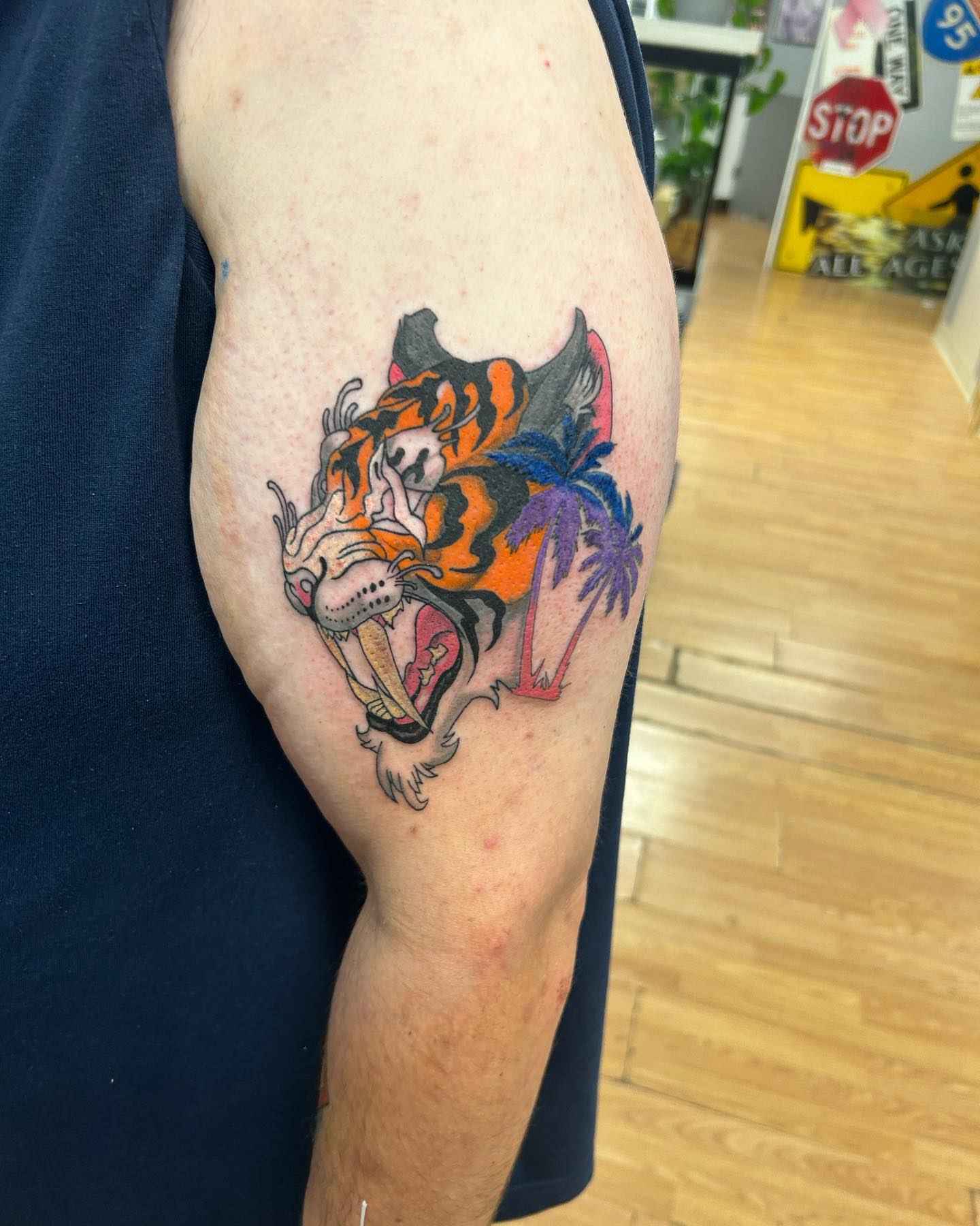 Tiger American traditional tattoo on the upper arm by Cameron 🩸👻