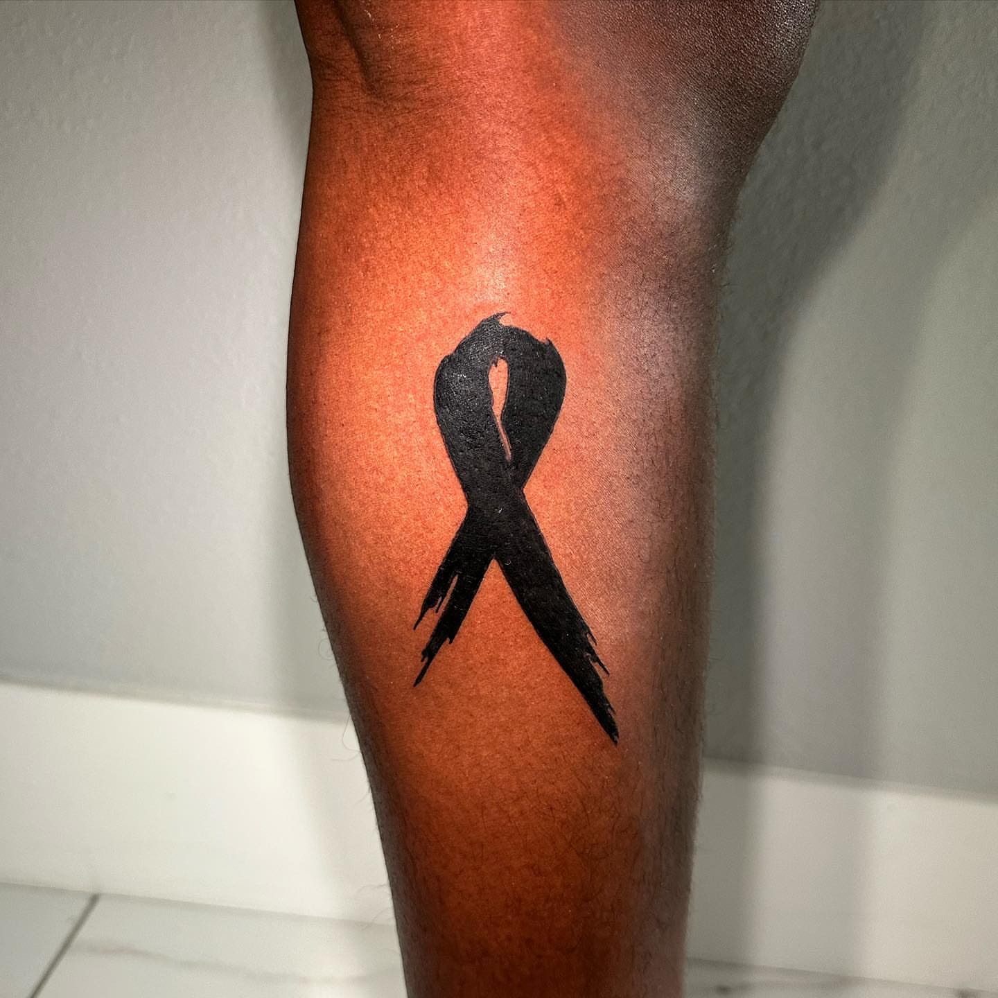 Black ribbon black and grey tattoo on the forearm by Kerusha (Bay Area Tattoo Artist)