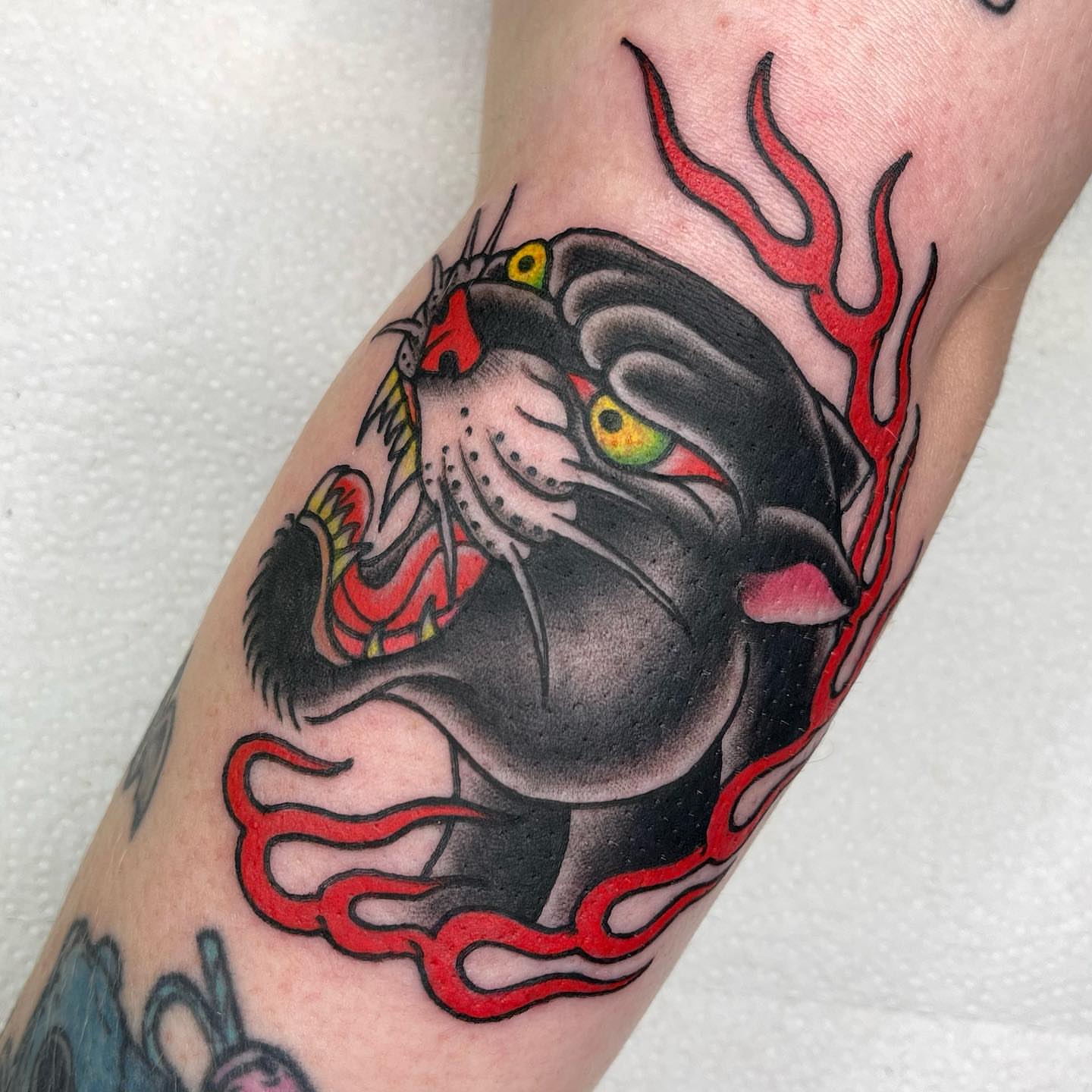 Panther American traditional tattoo on the forearm by Lexx Christine
