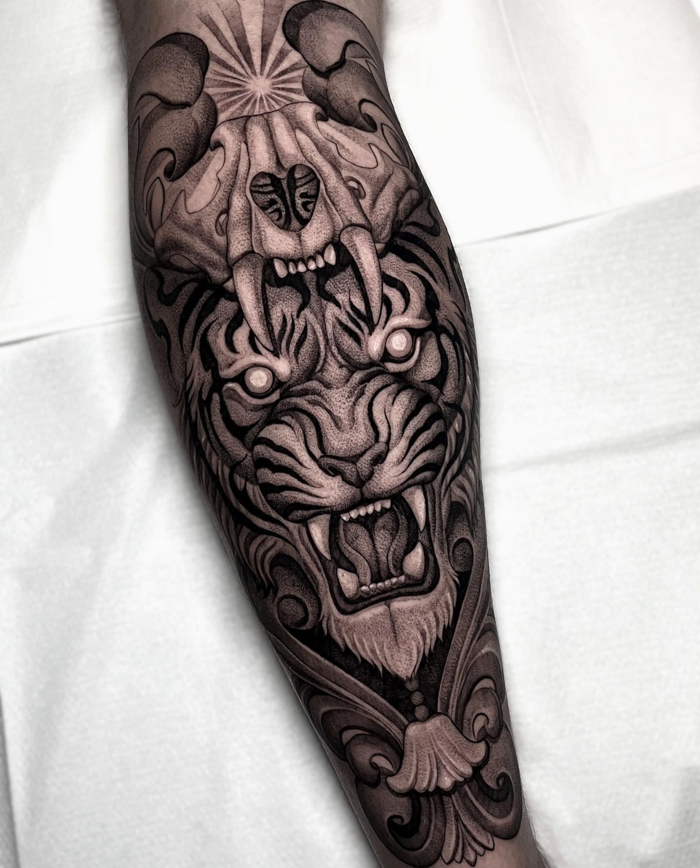 Tiger skull realism tattoo on the forearm by Enrique Martinez