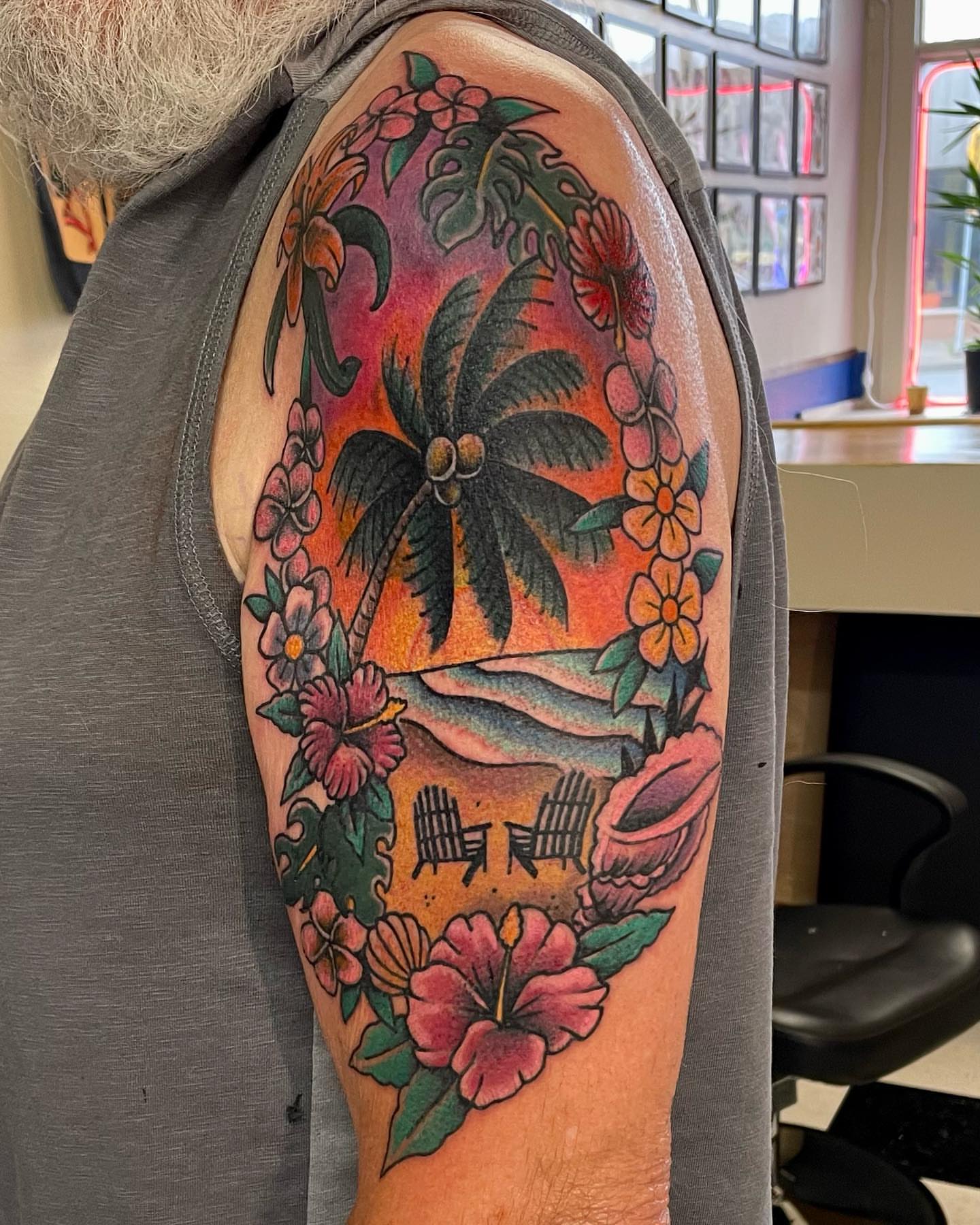 Beach scene American traditional tattoo on the upper arm by Don Robison