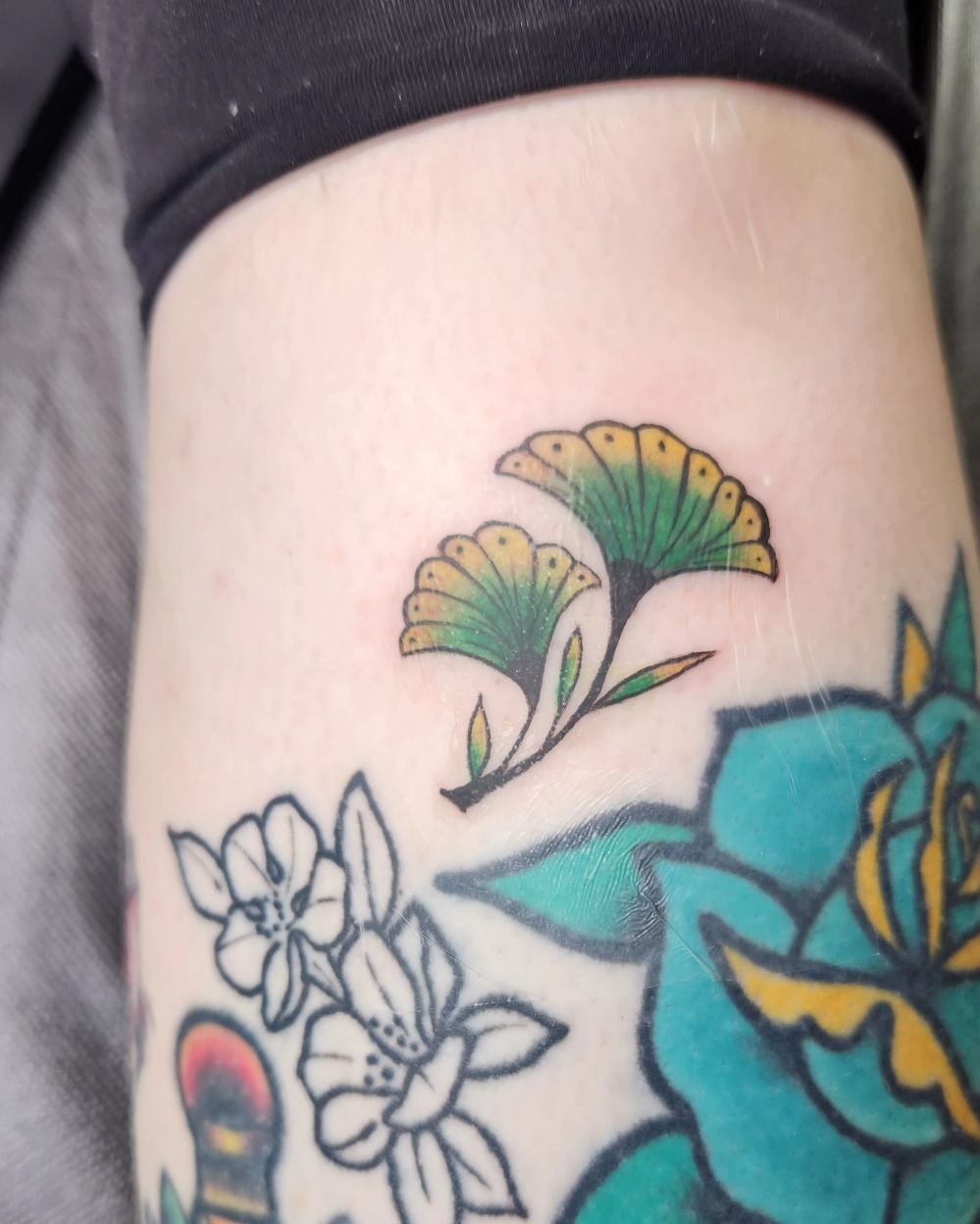 Ginger leaves American traditional tattoo on the thigh by Audrey Luther