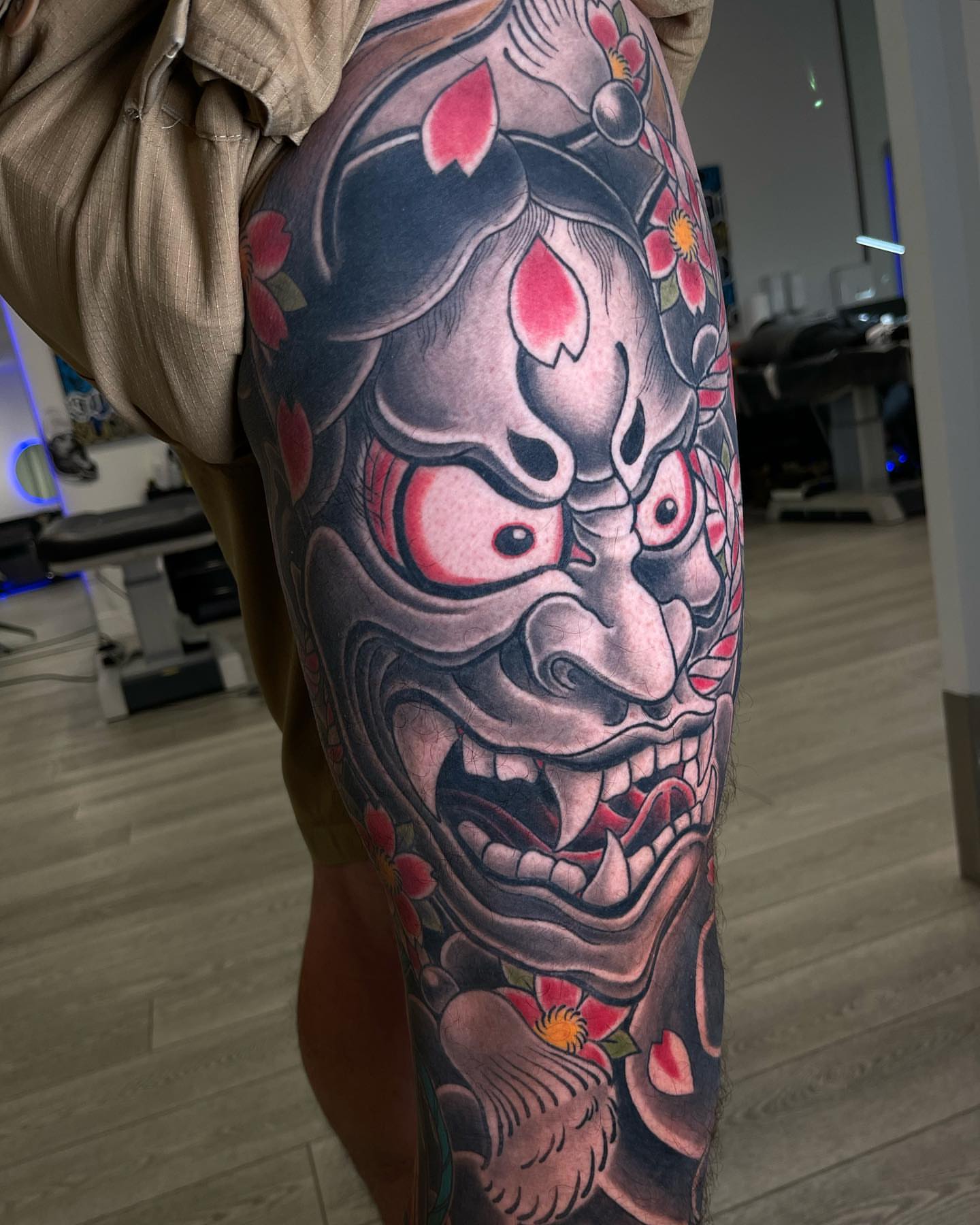 Japanese mask American traditional tattoo on the thigh by Claude Steven Estrada, Las Vegas, Nevada