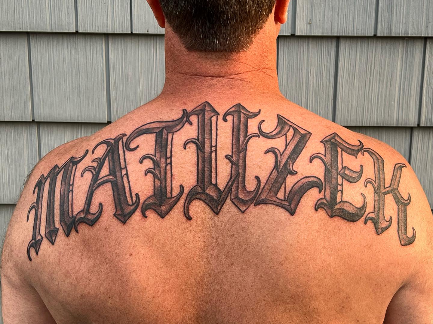Script lettering lettering script tattoo on the back by Iconic Ink, Millbury, Massachusetts