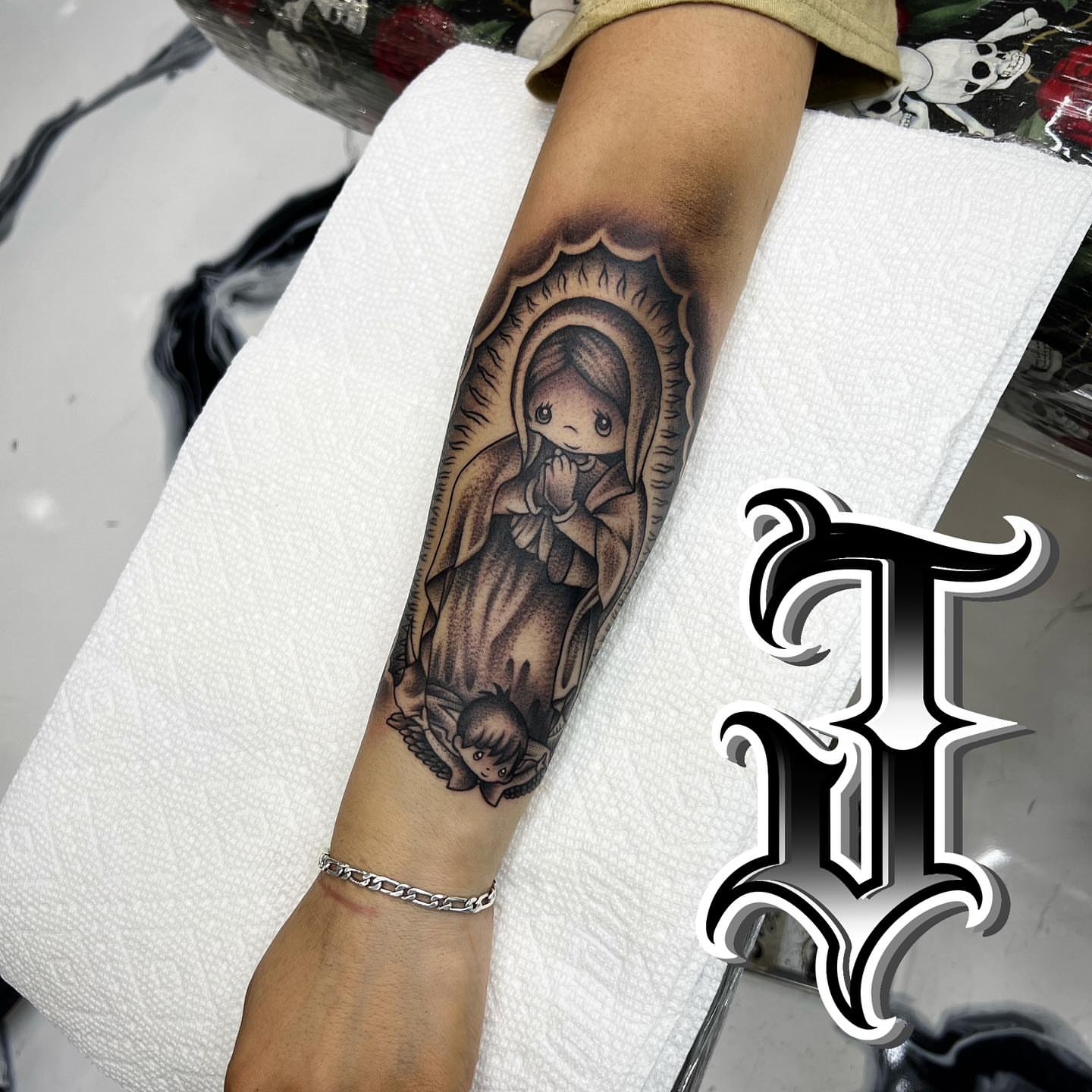 Religious figure black and grey tattoo on the forearm by Joseph Alvarado