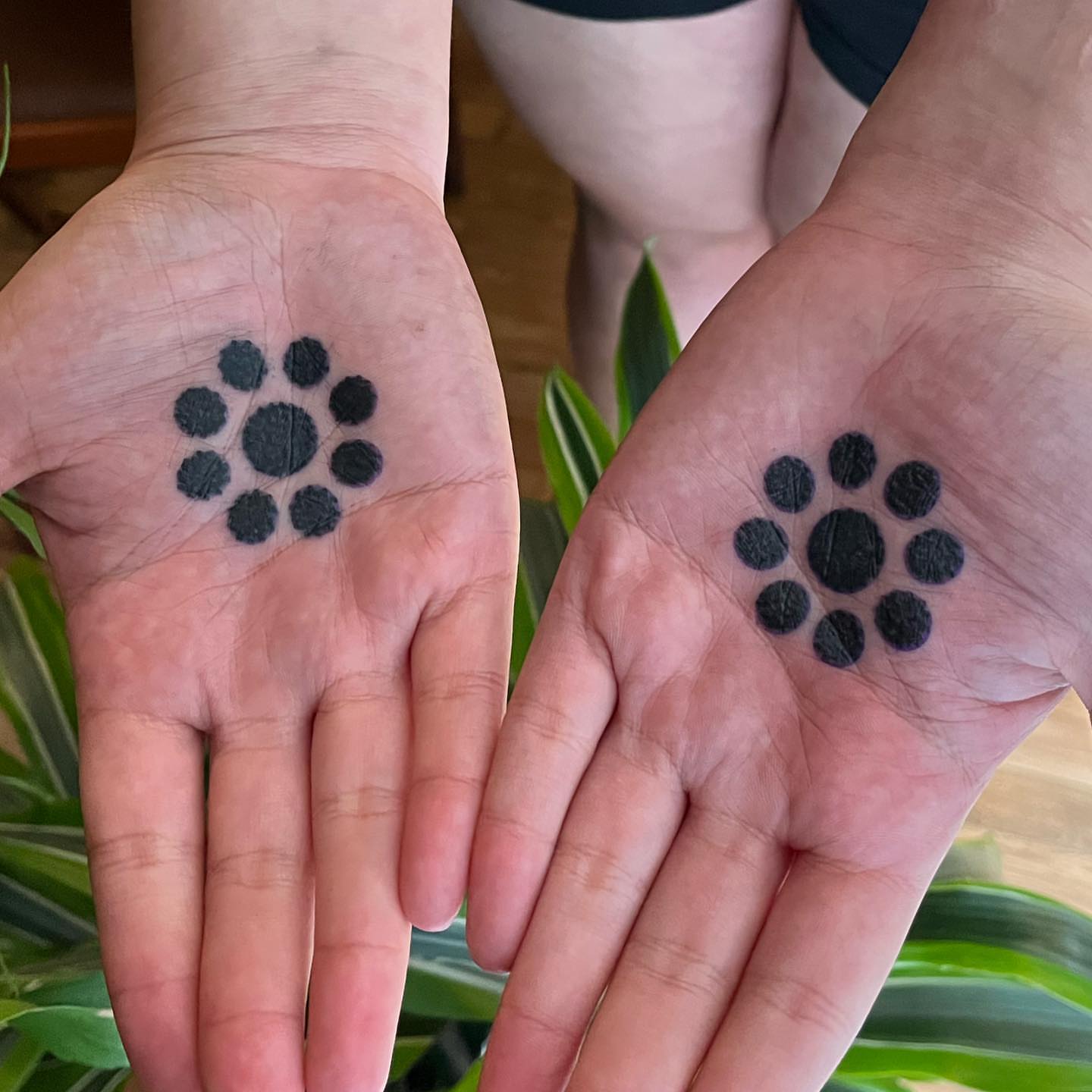 Paw print dotwork tattoo on the hand by kevvy