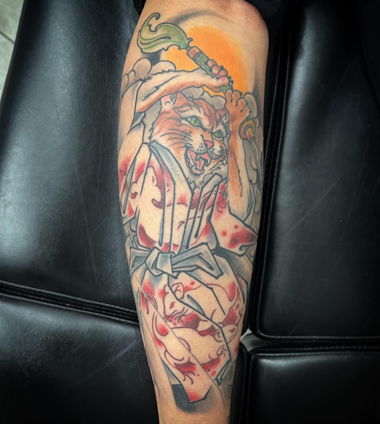 Lion and warrior American traditional tattoo on the forearm by biggstattoos