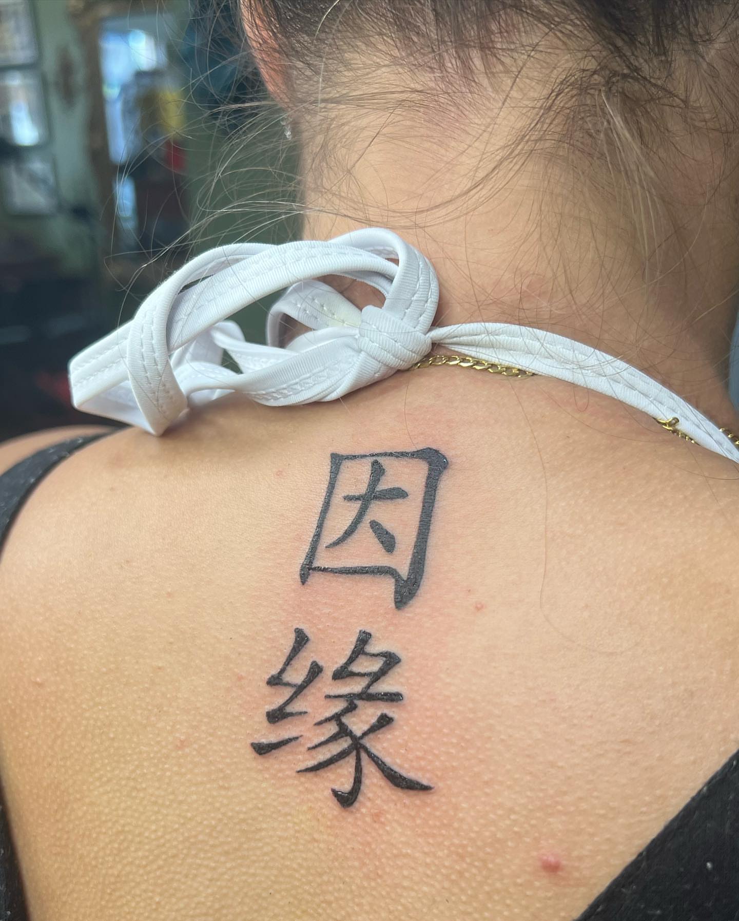 Kanji characters black and grey tattoo on the back by Hali Larkin