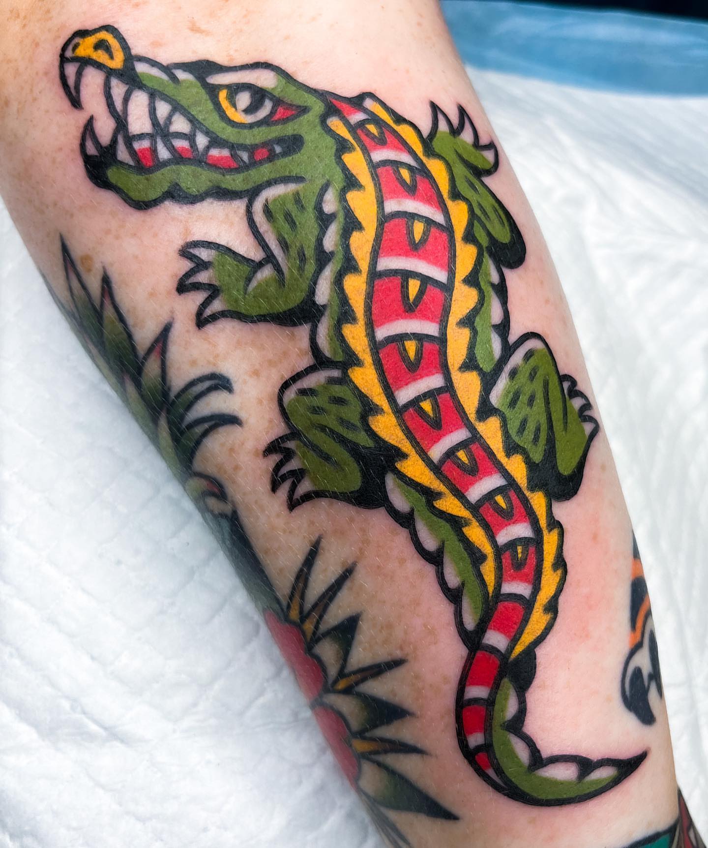 Alligator American traditional tattoo on the forearm by Oldschool Tattooer Takii 타키