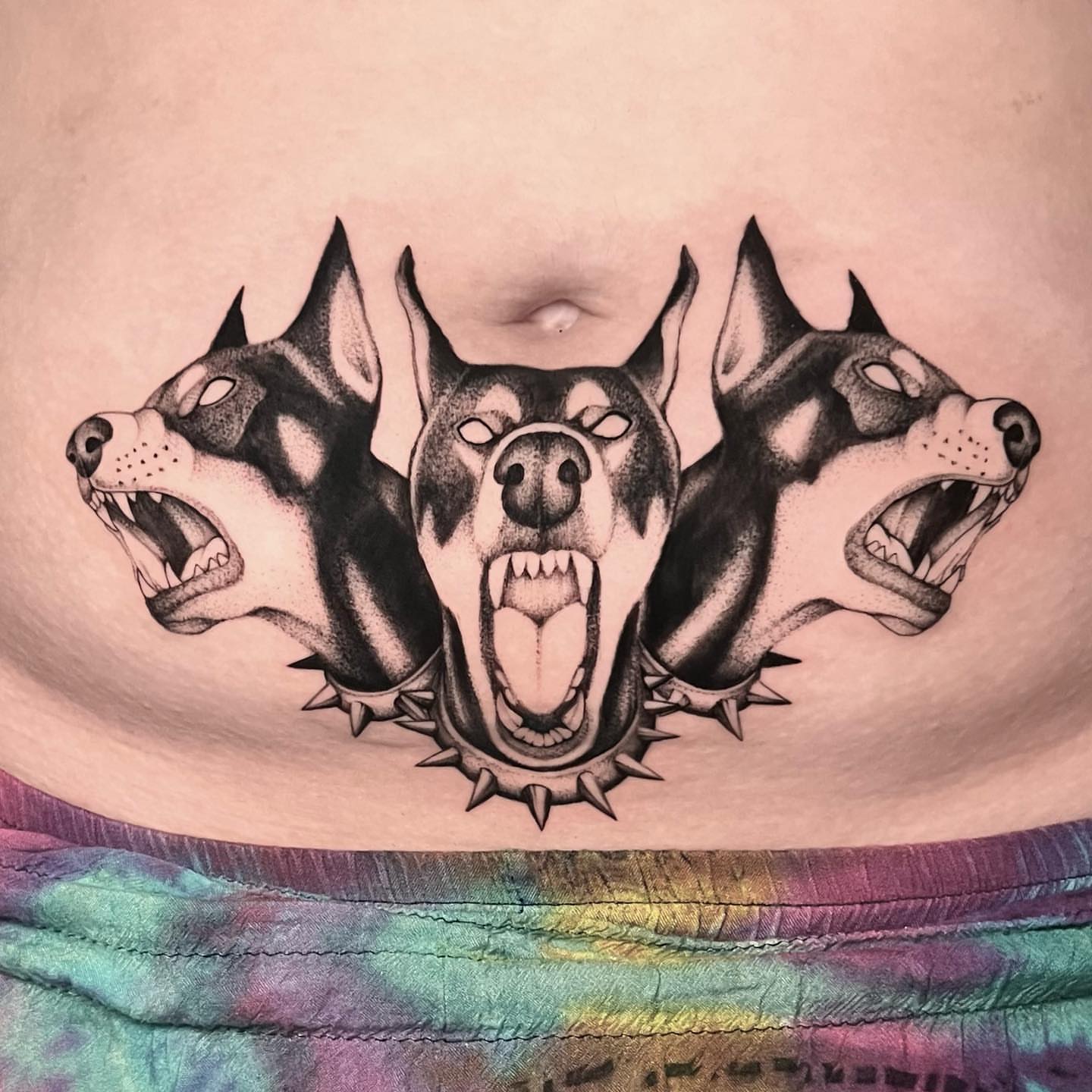 Three dogs black and grey tattoo on the torso by Chelsea Darling
