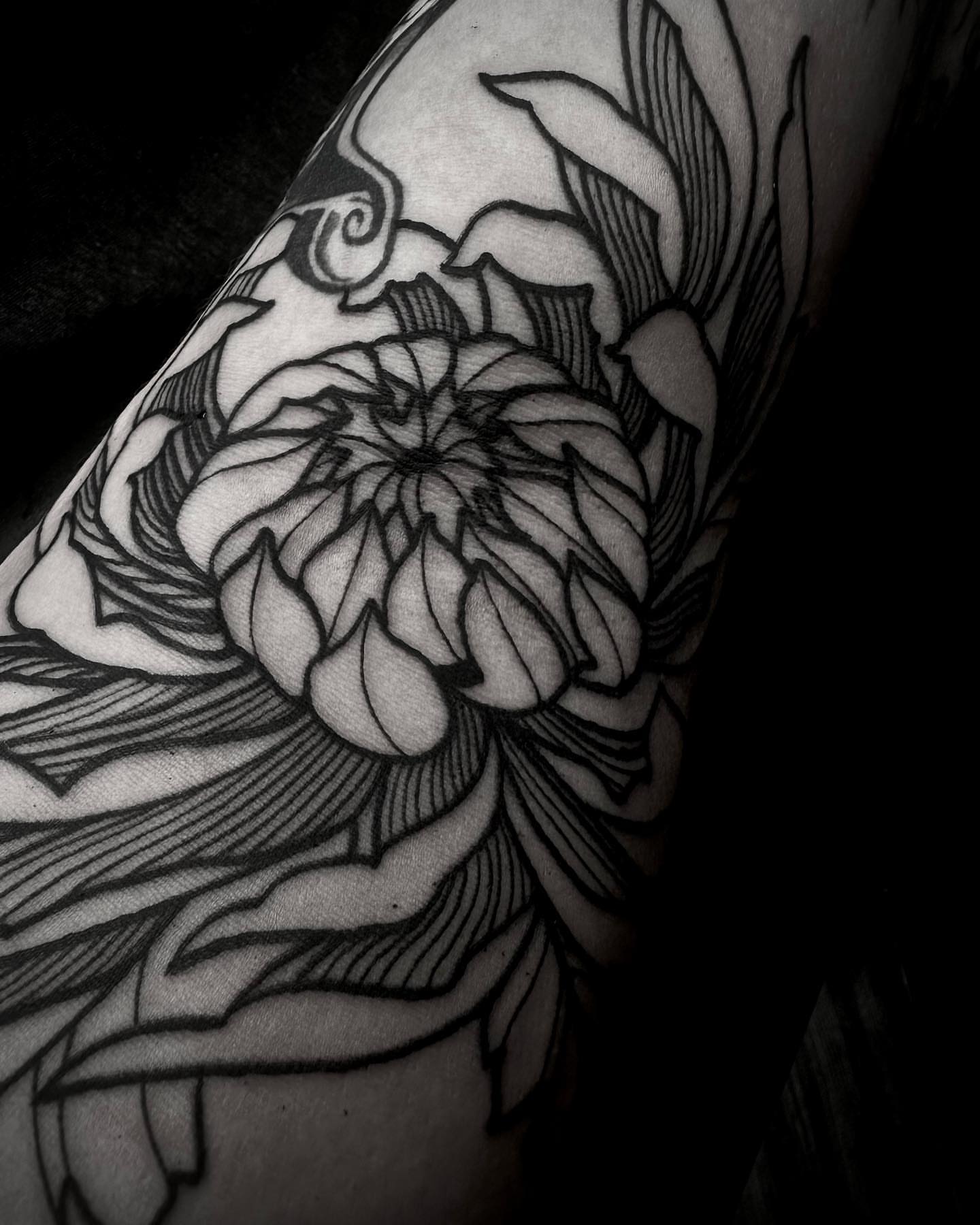 Flower black and grey tattoo on the upper arm by t a y l o r
