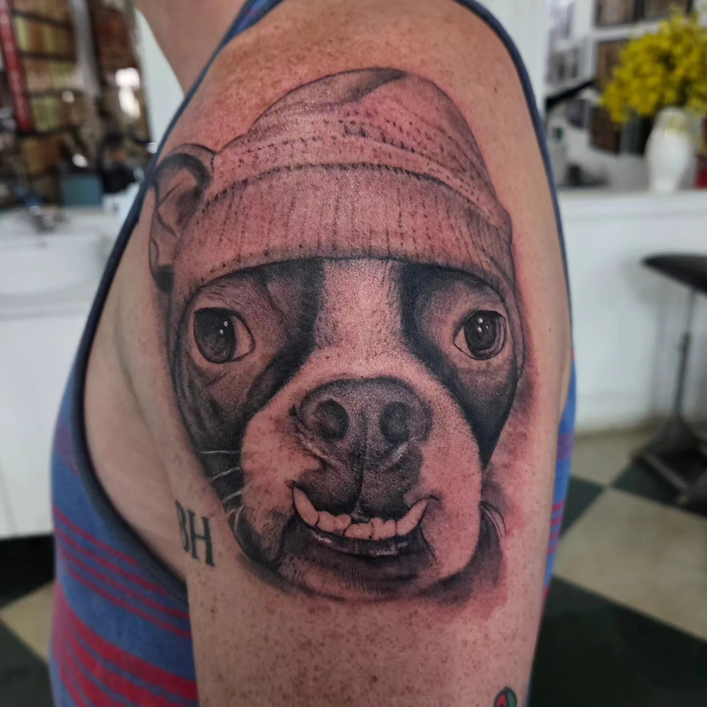 Dog wearing hat realism tattoo on the shoulder by David Nash, Evansville, Indiana