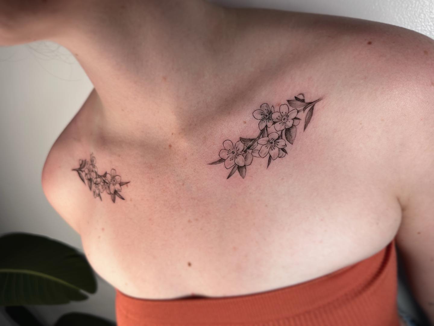 Cherry blossoms black and grey tattoo on the chest by Stephanie Shortsleeve