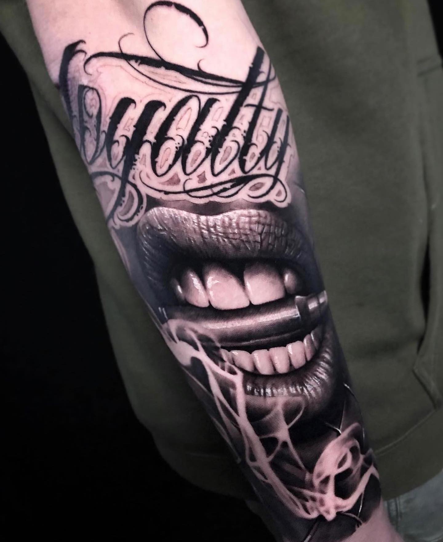 Mouth with cigarette realism tattoo on the forearm by Anton Martiushev
