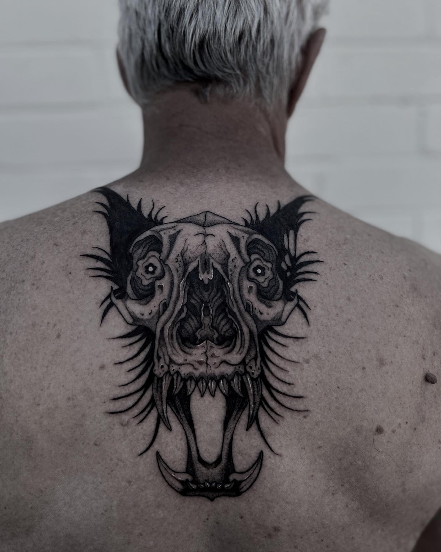 Skull black and grey tattoo on the back by Melanie