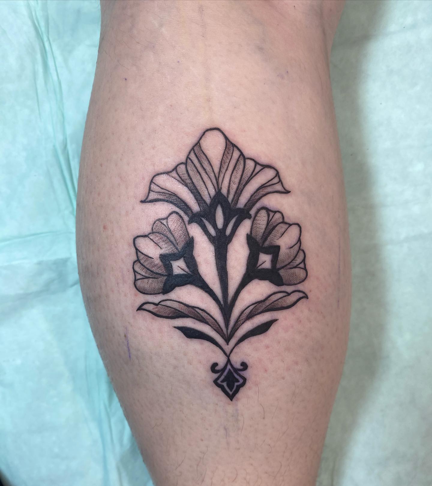 Floral ornament ornamental tattoo on the calf by Sally Darling