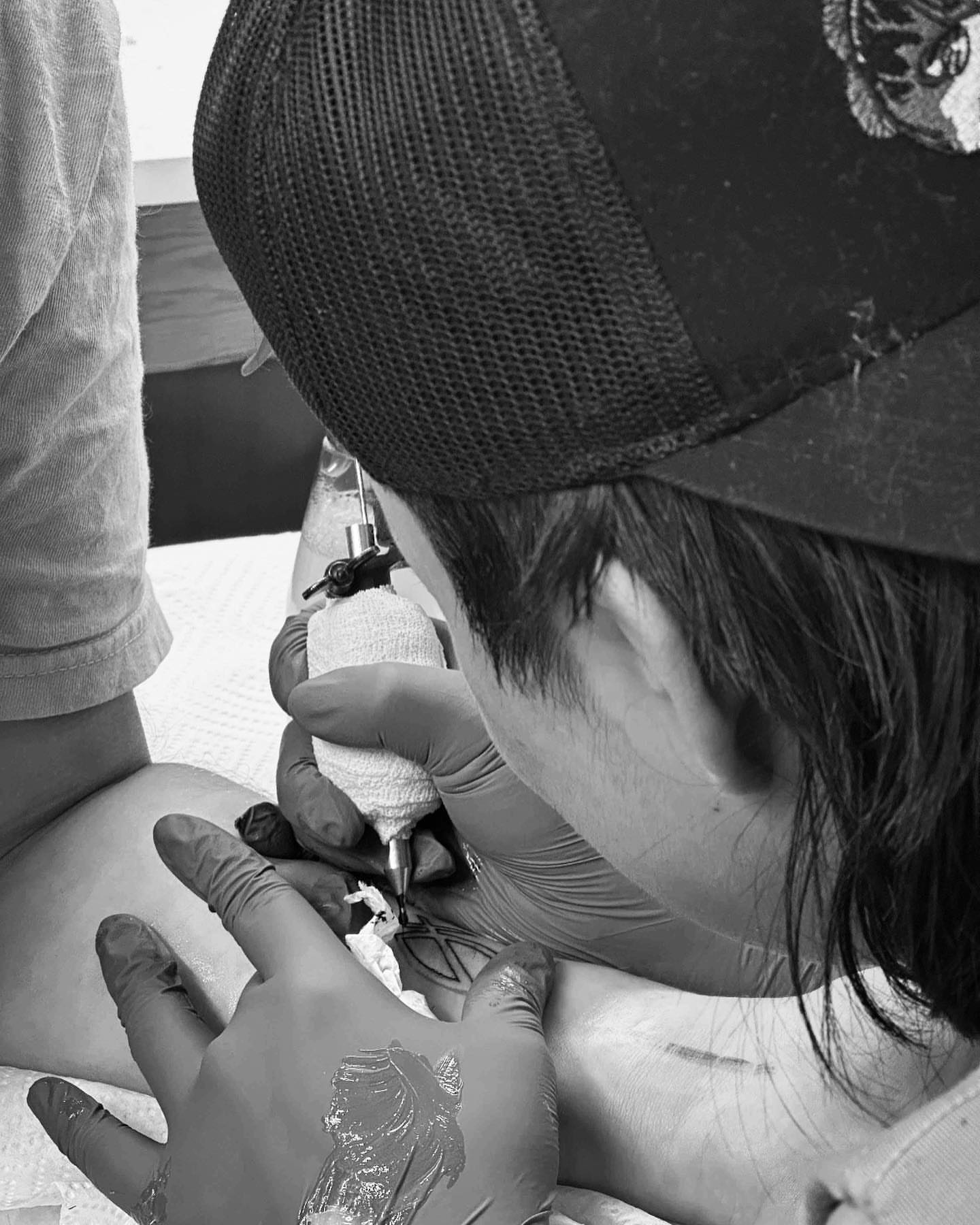 Feather black and grey tattoo on the back by Bear