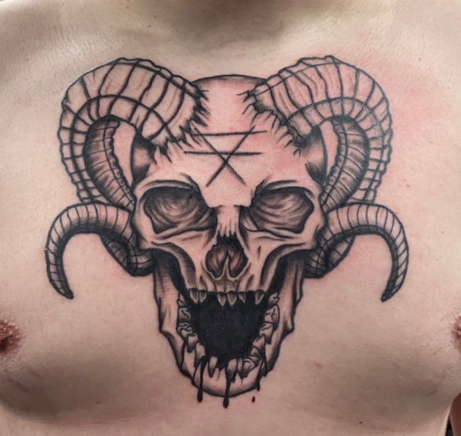 Skull with horns realism tattoo on the chest by Kenzie🖤